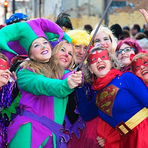 A group of happy girls dressed in different fantasy characters.