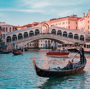 boat admist the water with a people enjoying the ride.